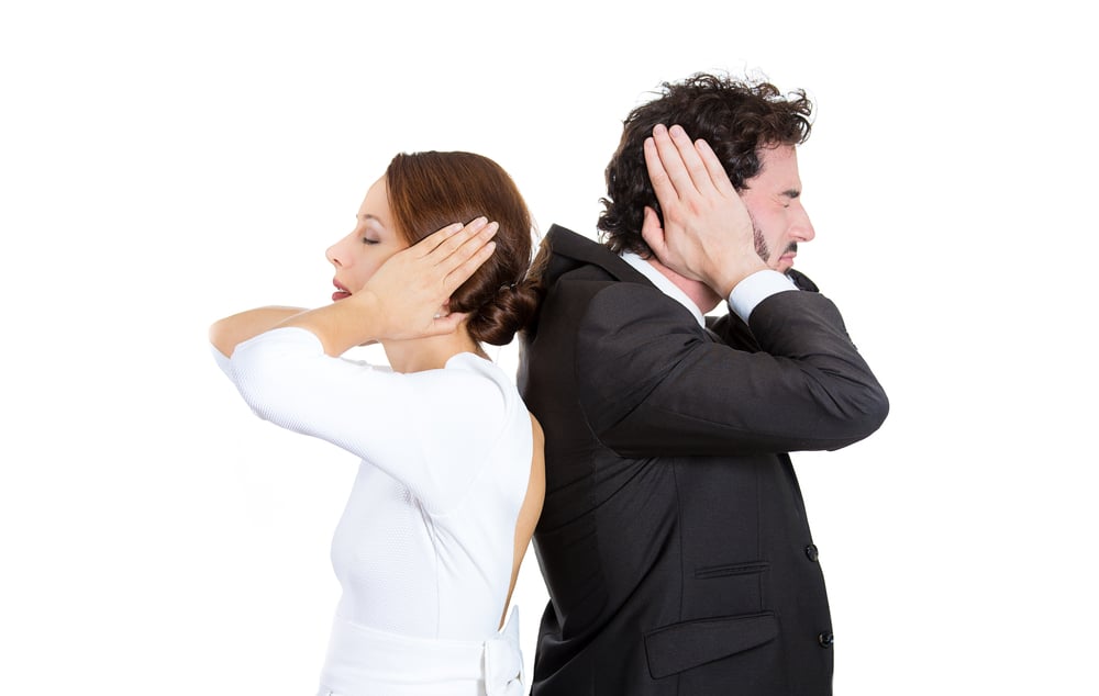 Closeup portrait of man woman couple standing with backs together covering ears, closed eyes, not listening to each other isolated on white background. Negative human emotions facial expressions